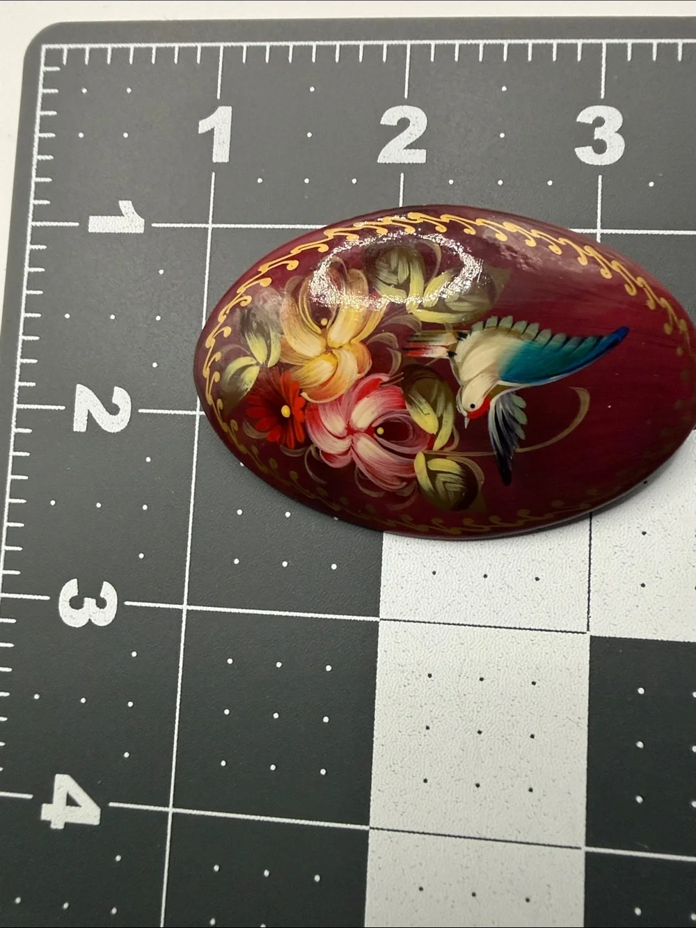 vintage Russian hand-painted lacquered wood brooch featuring a hummingbird among